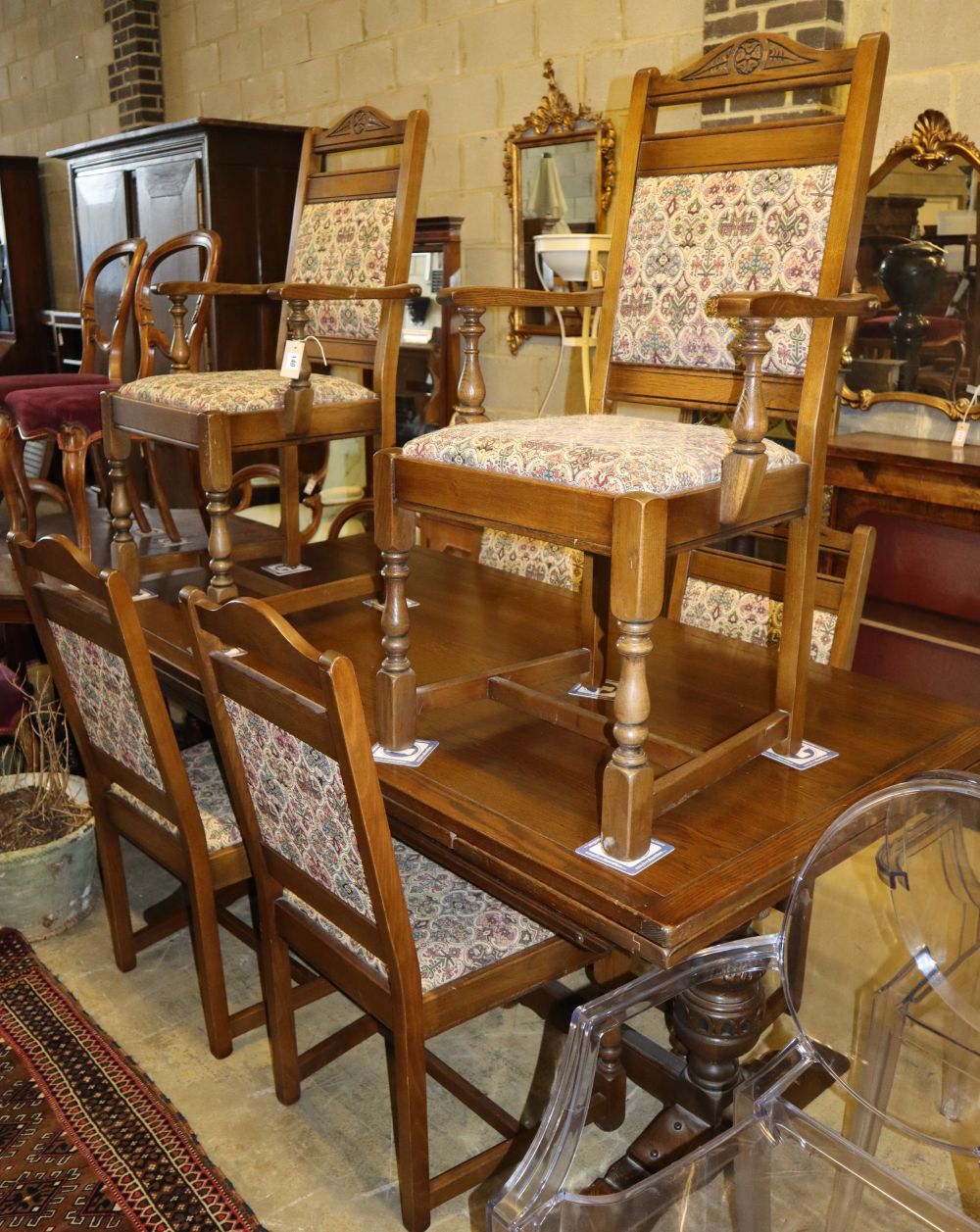 An 18th century design oak draw leaf dining table, 260cm extended, W.91cm, H.79cm and six chairs (two with arms)